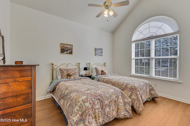 bedroom featuring hardwood / wood-style flooring, ceiling fan, and lofted ceiling