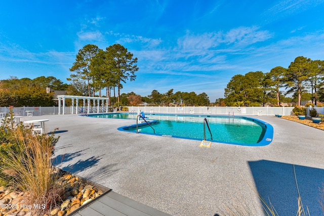 view of swimming pool featuring a pergola and a patio area