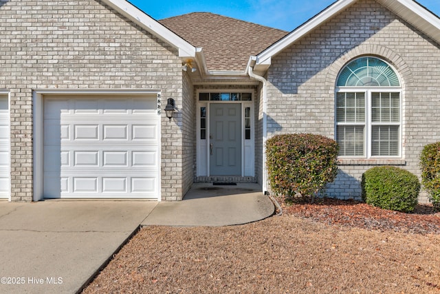 view of exterior entry with a garage