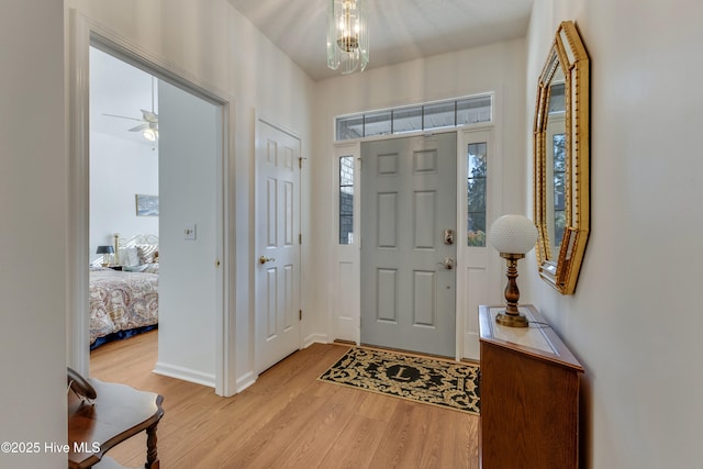 entrance foyer featuring an inviting chandelier and light hardwood / wood-style flooring