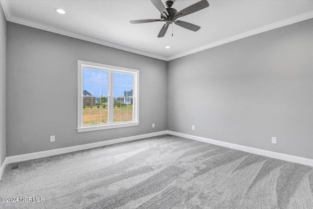 spare room featuring crown molding, carpet, and ceiling fan