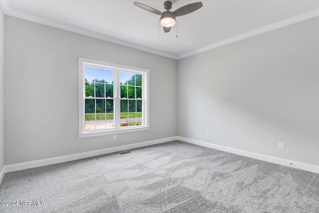 carpeted spare room featuring ceiling fan and ornamental molding