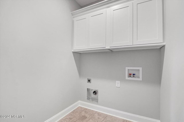 clothes washing area featuring electric dryer hookup, washer hookup, and cabinets