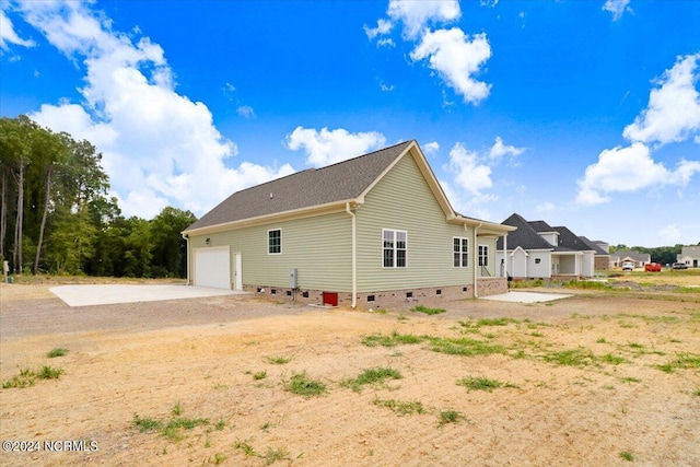 rear view of house with a garage