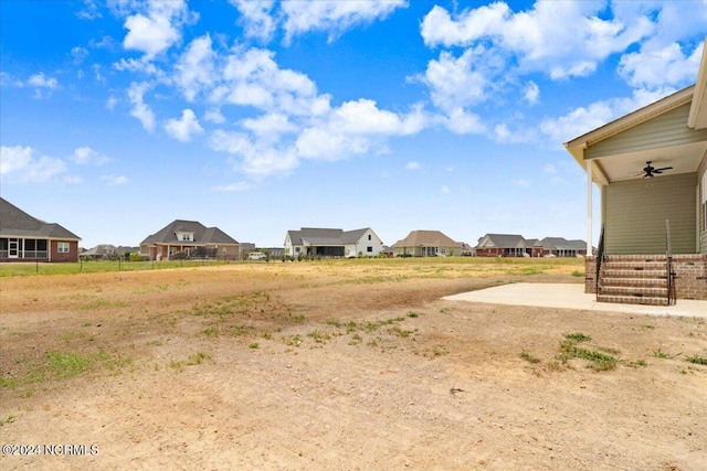 view of yard with a patio area and ceiling fan