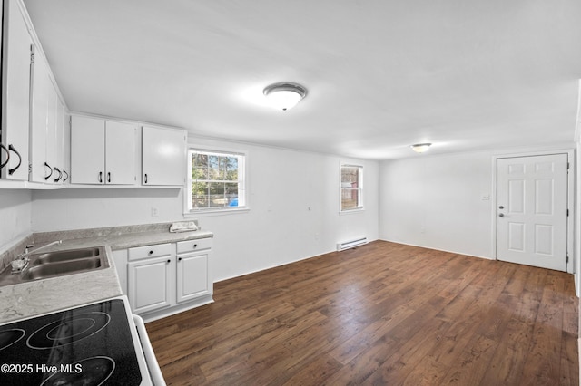 kitchen with white cabinetry, sink, dark wood-type flooring, and baseboard heating