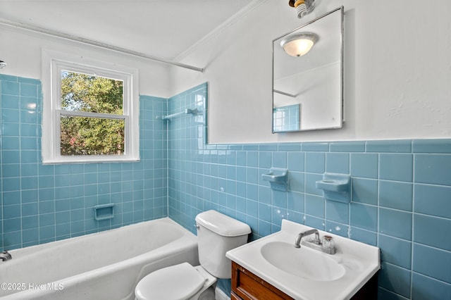 full bathroom featuring tiled shower / bath combo, vanity, tile walls, and toilet