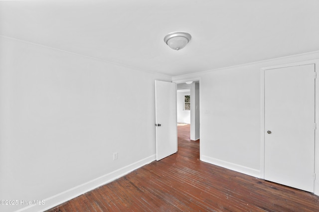 spare room with dark wood-type flooring