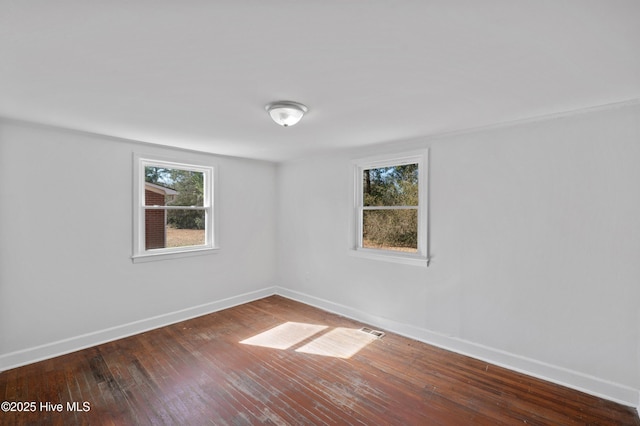 spare room with wood-type flooring