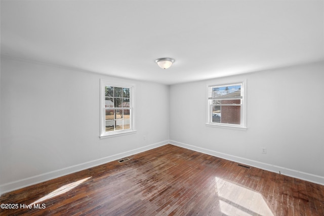 spare room with dark hardwood / wood-style floors