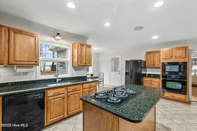 kitchen with sink, a center island, light tile patterned floors, ornamental molding, and black appliances