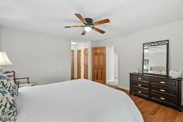 bedroom with hardwood / wood-style floors and ceiling fan