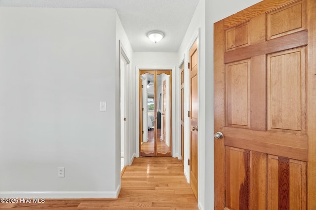 hallway with light wood-type flooring