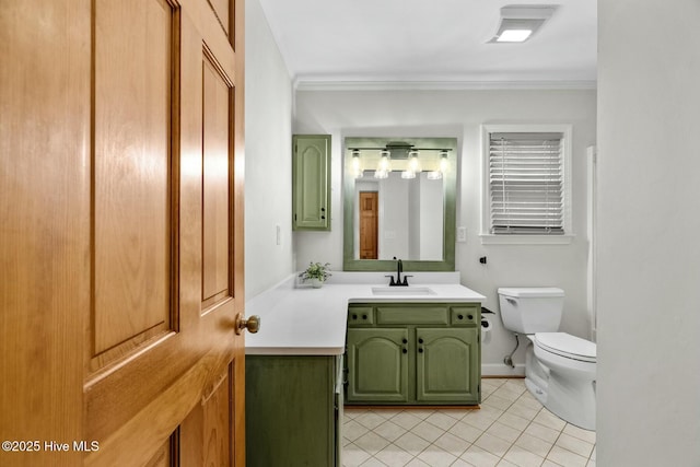 bathroom featuring vanity, ornamental molding, tile patterned floors, and toilet