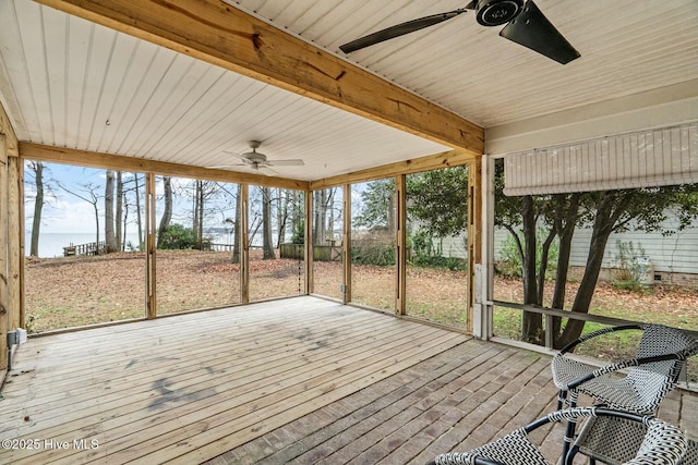 unfurnished sunroom with beam ceiling and ceiling fan