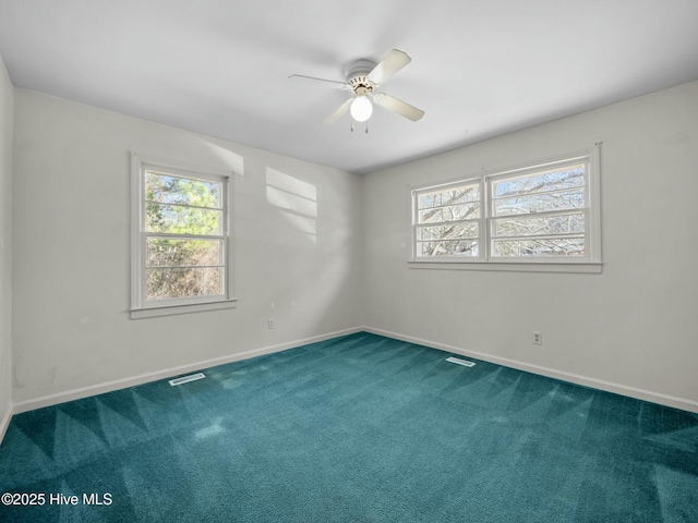 spare room with ceiling fan, a healthy amount of sunlight, and carpet flooring