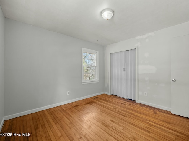 unfurnished bedroom featuring a closet and light wood-type flooring