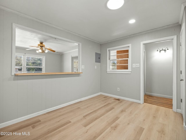 spare room featuring ornamental molding, ceiling fan, and light hardwood / wood-style floors