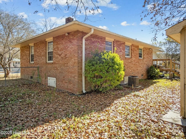 view of side of home with central AC