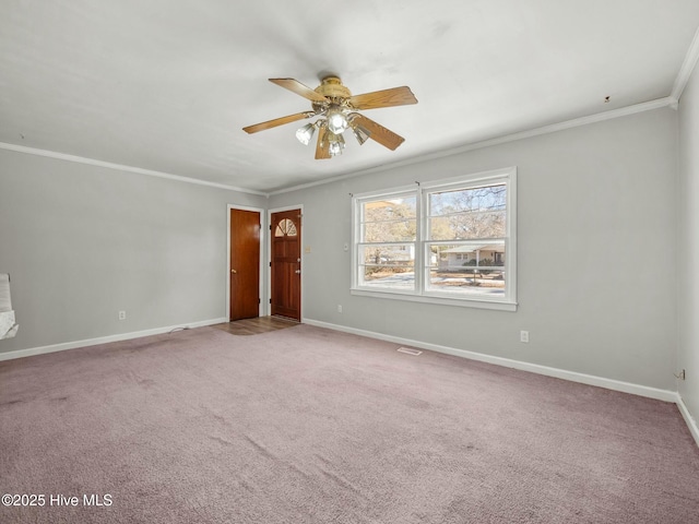 carpeted spare room featuring ornamental molding and ceiling fan