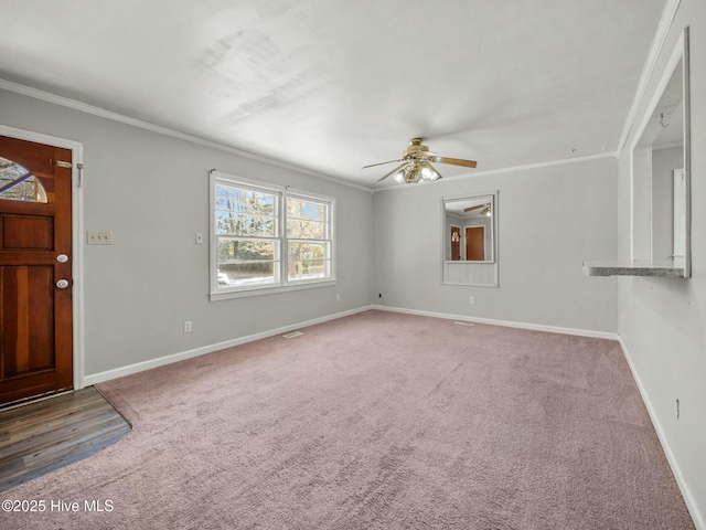 foyer featuring ornamental molding, ceiling fan, and carpet flooring