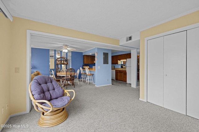 living area with ceiling fan and carpet floors