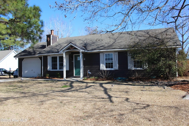 ranch-style house featuring a garage and a front yard