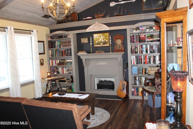 sitting room featuring dark hardwood / wood-style flooring, lofted ceiling, and an inviting chandelier