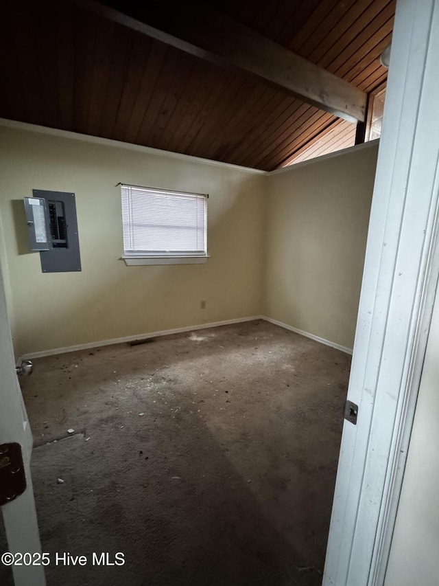 spare room featuring electric panel and vaulted ceiling with beams