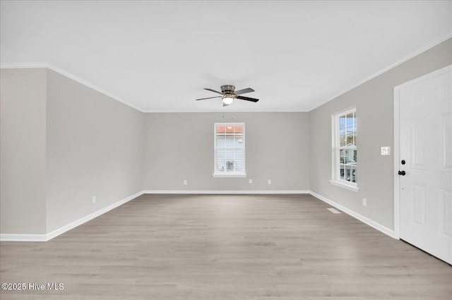 interior space with light wood-style flooring, ornamental molding, ceiling fan, and baseboards