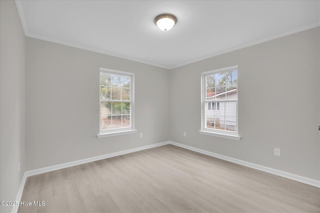 unfurnished room with a wealth of natural light and baseboards