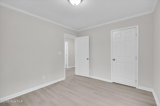 unfurnished bedroom with baseboards, light wood-style flooring, and crown molding