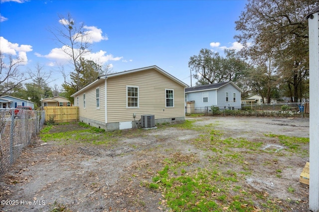 rear view of property featuring crawl space, fence, and central air condition unit