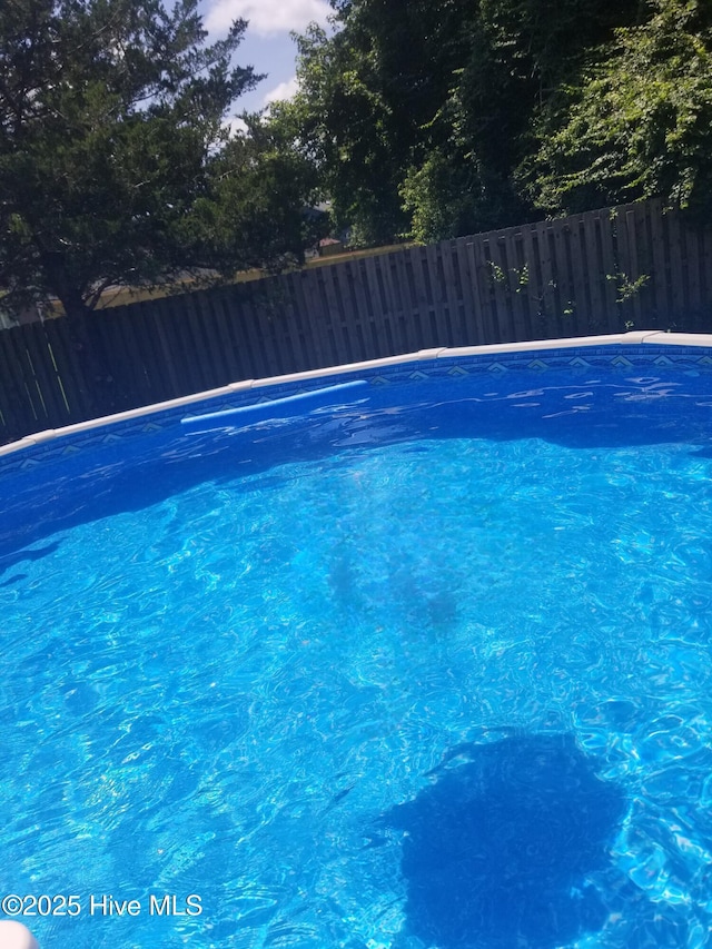 view of pool at dusk