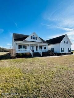 view of front of home featuring a front lawn and covered porch