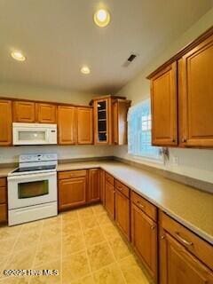 kitchen with light tile patterned floors and white appliances