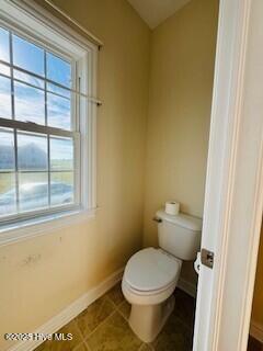 bathroom featuring tile patterned flooring and toilet