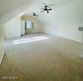 bonus room with light carpet, lofted ceiling, and ceiling fan