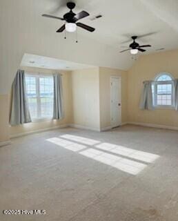 carpeted spare room with vaulted ceiling and ceiling fan