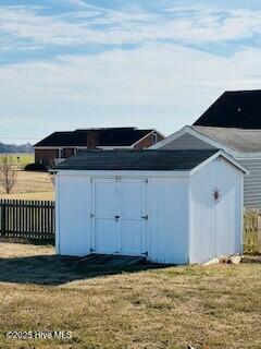 view of outbuilding featuring a yard