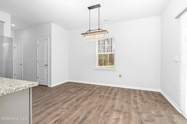 unfurnished dining area with visible vents, baseboards, and dark wood-type flooring