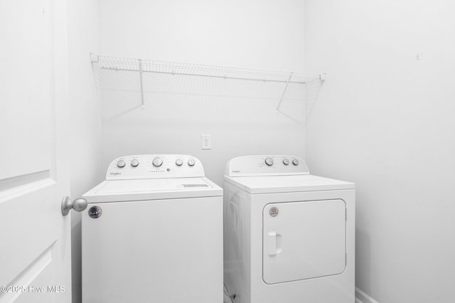 washroom featuring laundry area and washing machine and clothes dryer