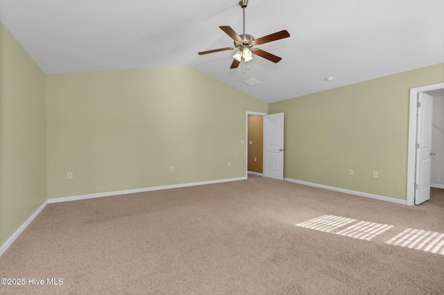 unfurnished room with lofted ceiling, carpet, a ceiling fan, and baseboards