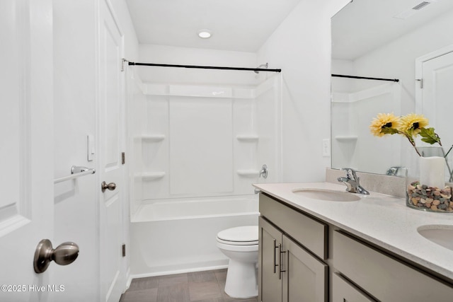 full bathroom featuring toilet, double vanity, a sink, and visible vents