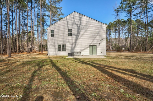 back of property featuring a patio area and a lawn