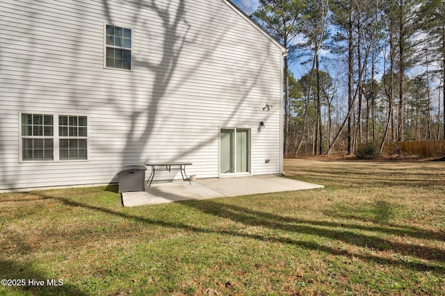 back of property featuring a patio and a lawn