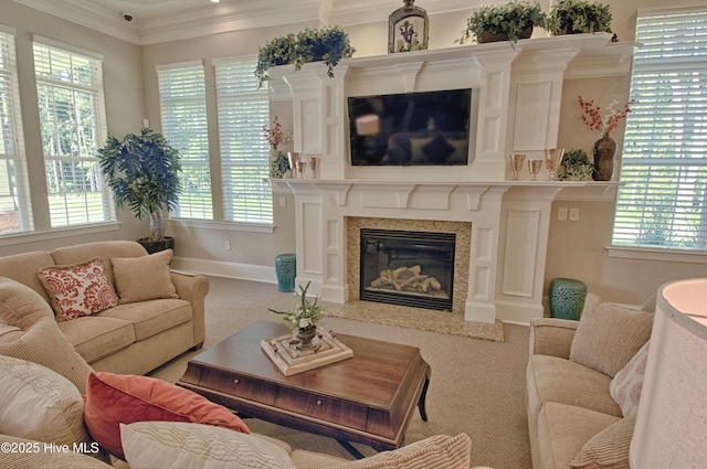 carpeted living room featuring ornamental molding, a fireplace, and baseboards