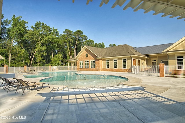 community pool featuring a patio and fence