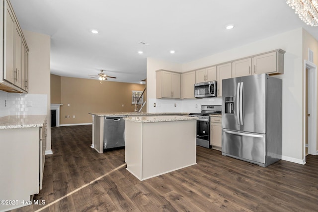 kitchen featuring appliances with stainless steel finishes, gray cabinets, dark wood finished floors, and ceiling fan