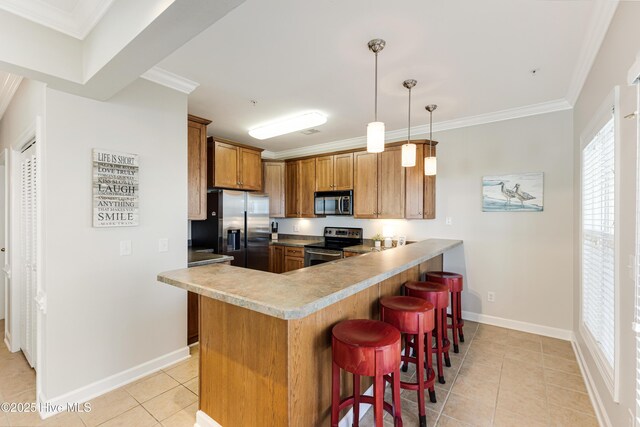 kitchen with decorative light fixtures, a breakfast bar area, ornamental molding, kitchen peninsula, and stainless steel appliances